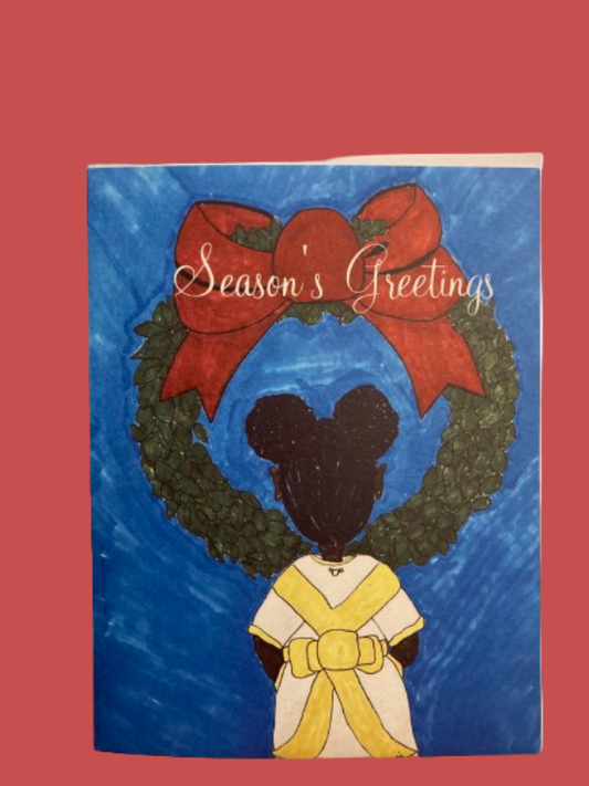 Christmas card with a wreath, red bow, and silhouette of a person in a yellow dress on a blue background.